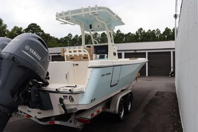Slide: The Image of 2023 Sea Born LX26 boat on trailer with Yamaha engine, parked outdoors. - 6