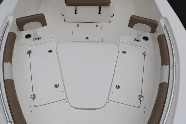 Slide: The Image of 2023 Sea Born LX26 boat interior with cushioned seating and storage compartments. - 7