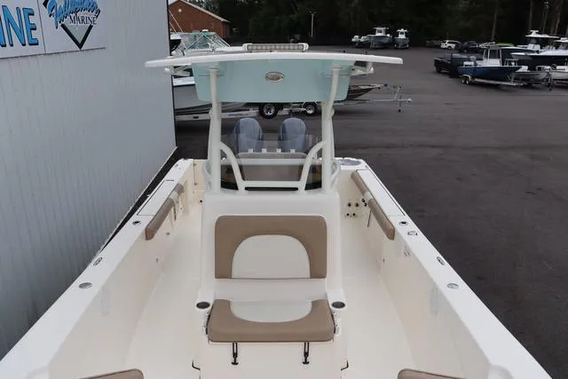 Slide: The Image of 2023 Sea Born LX26 boat with center console and seating, displayed at a marina. - 8