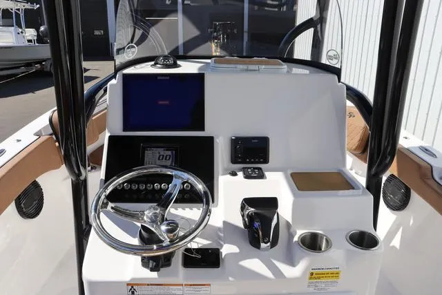 Slide: The Image of 2023 Sea Pro 219 Deep V Series boat console with steering wheel and controls. - 10