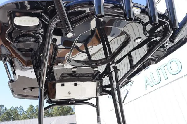 Slide: The Image of 2023 Sea Pro 219 Deep V Series boat, black T-top with rod holders and lights. - 14