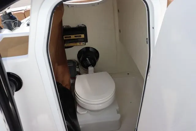 Slide: The Image of 2023 Sea Pro 219 Deep V Series boat interior with compact marine toilet. - 15
