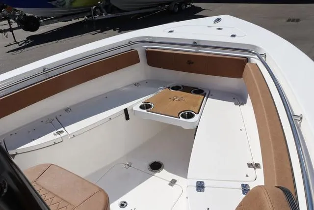 Slide: The Image of 2023 Sea Pro 219 Deep V Series boat interior with seating and table. - 16