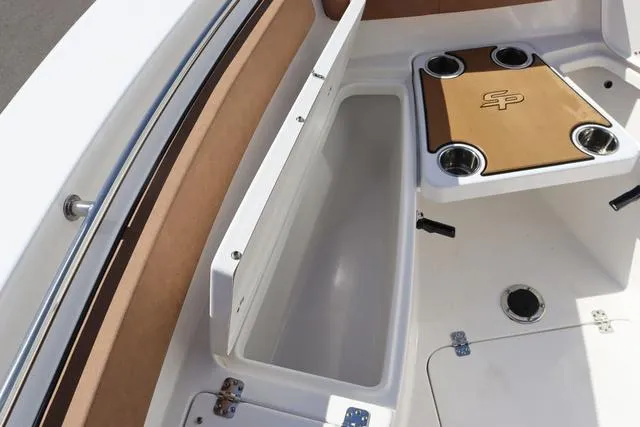 Slide: The Image of 2023 Sea Pro 219 Deep V Series boat interior with storage and cup holders. - 17