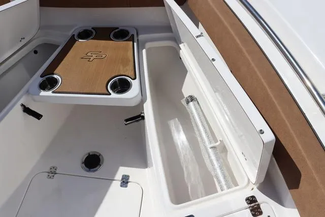 Slide: The Image of 2023 Sea Pro 219 Deep V Series boat interior with storage compartments and table. - 18