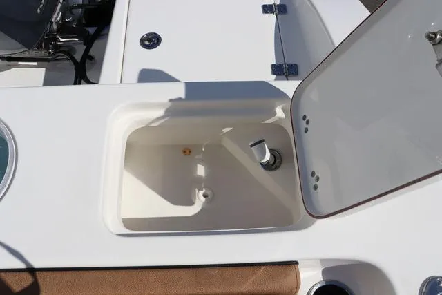 Slide: The Image of 2023 Sea Pro 219 Deep V Series boat compartment with open hatch, showcasing interior details. - 21