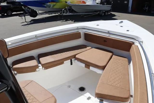 Slide: The Image of 2023 Sea Pro 219 Deep V Series boat with tan cushioned seating in the bow area. - 6