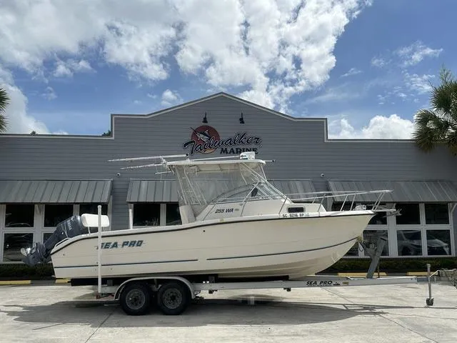 Slide: The Image of 1997 Sea Pro 255 WA boat on trailer outside Tailwalker Marine building. - 1