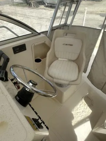 Slide: The Image of 1997 Sea Pro 255 WA boat interior with steering wheel and captain's chair. - 14