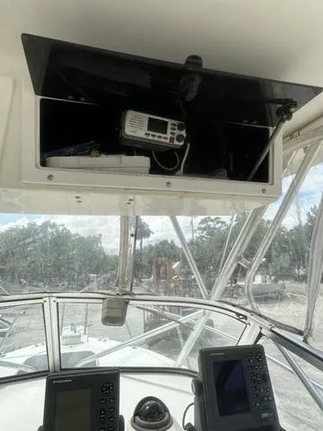 Slide: The Image of 1997 Sea Pro 255 WA boat cockpit with navigation equipment and open storage compartment. - 15