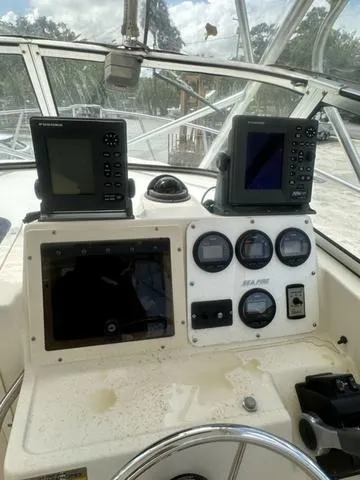 Slide: The Image of 1997 Sea Pro 255 WA boat dashboard with navigation instruments and gauges. - 16