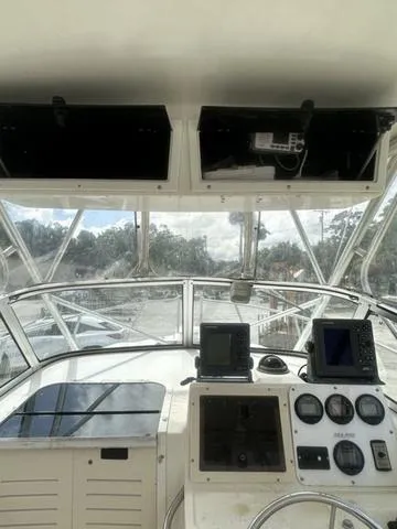 Slide: The Image of 1997 Sea Pro 255 WA boat cockpit with navigation instruments and open water view. - 17