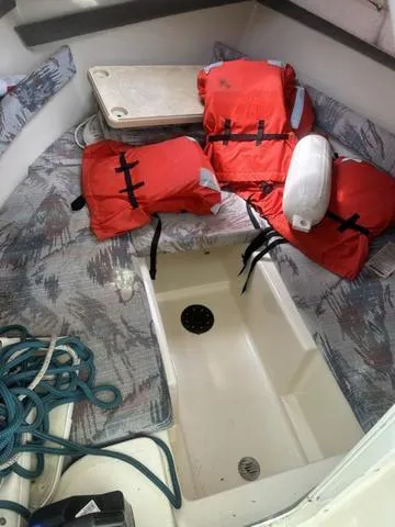 Slide: The Image of 1997 Sea Pro 255 WA cabin with life jackets and nautical equipment. - 18