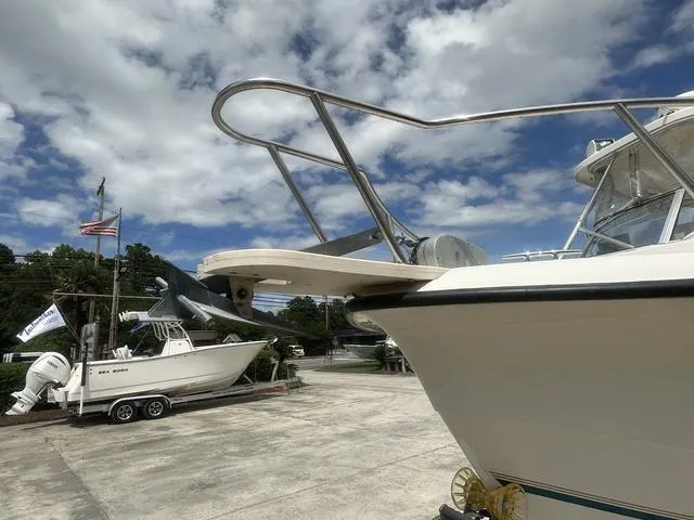 Slide: The Image of 1997 Sea Pro 255 WA boat on trailer, clear sky, American flag in background. - 3