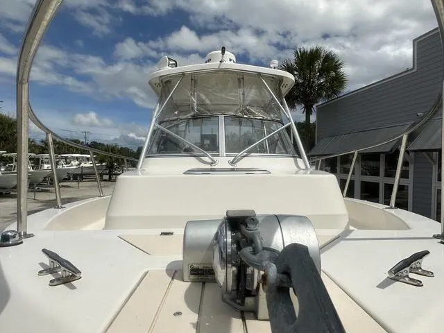 Slide: The Image of 1997 Sea Pro 255 WA boat with anchor, docked under cloudy sky. - 4