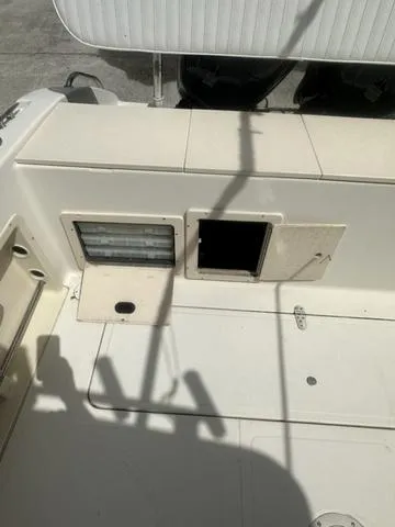 Slide: The Image of 1997 Sea Pro 255 WA boat deck with storage compartments and clean surface. - 8