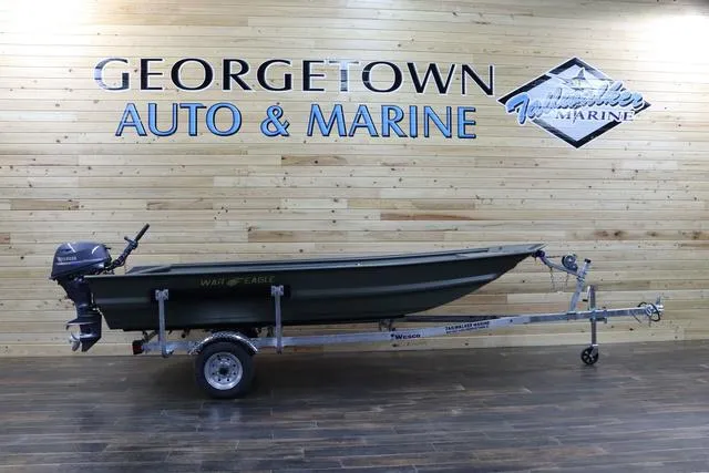 Slide: The Image of 2025 War Eagle 548LDV boat on trailer at Georgetown Auto & Marine showroom. - 1