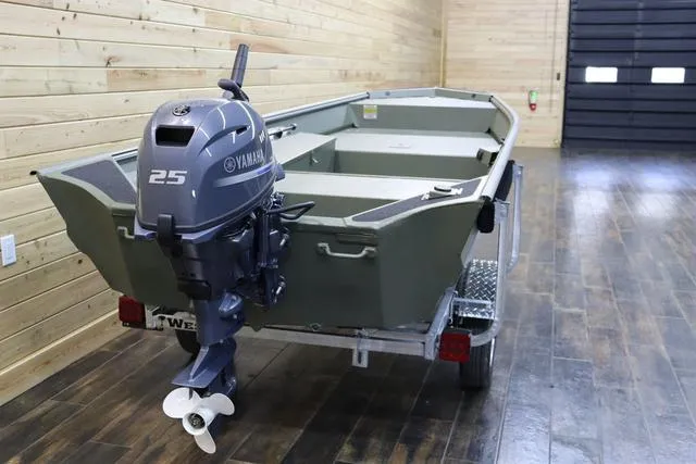 Slide: The Image of 2025 War Eagle 548LDV boat with Yamaha 25 outboard motor in a wooden interior setting. - 2