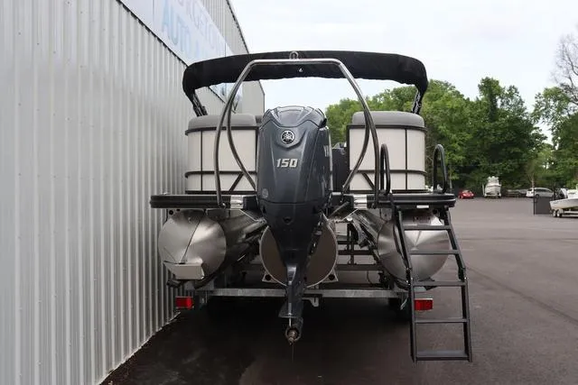 Slide: The Image of 2024 Bennington 22 SSR-SPS pontoon boat with Yamaha 150 engine, parked outdoors. - 11