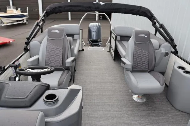Slide: The Image of 2024 Bennington 22 SSR-SPS pontoon boat interior with gray seating and steering console. - 16