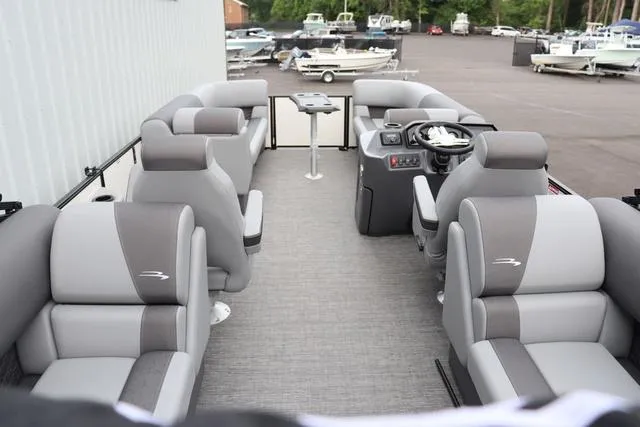 Slide: The Image of 2024 Bennington 22 SSR-SPS pontoon boat interior with gray seating and steering console. - 19