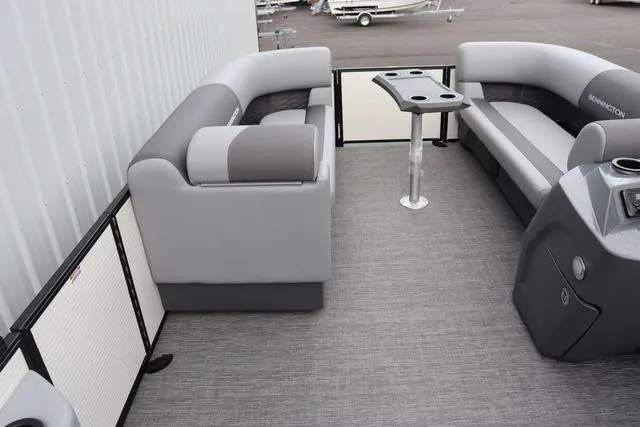 Slide: The Image of 2024 Bennington 22 SSR-SPS pontoon boat interior with gray seating and table. - 21