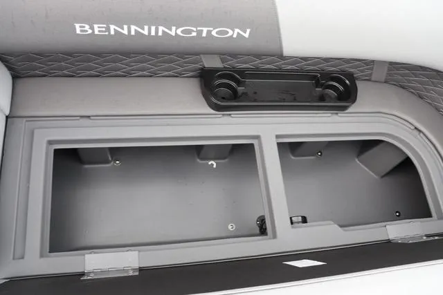 Slide: The Image of 2024 Bennington 22 SSR-SPS boat storage compartment with cup holders and quilted upholstery. - 26
