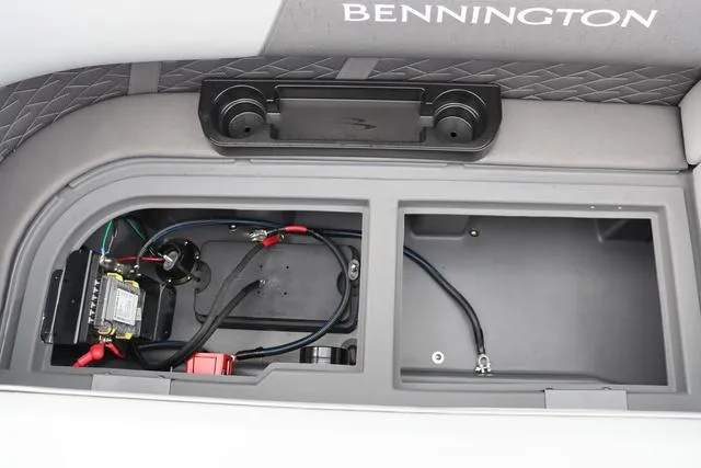 Slide: The Image of 2024 Bennington 22 SSR-SPS boat storage compartment with wiring and cup holders. - 28