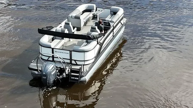 Slide: The Image of 2024 Bennington 22 SSR-SPS pontoon boat on water, featuring spacious seating and modern design. - 3