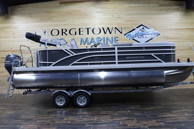 Slide: The Image of 2024 Bennington 22 SVL pontoon boat displayed at Georgetown Auto & Marine showroom. - 1