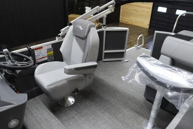 Slide: The Image of 2024 Bennington 22 SVL boat interior with captain's chair and table. - 13