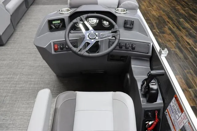 Slide: The Image of 2024 Bennington 22 SVL boat dashboard with steering wheel and control panel. - 16