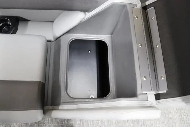 Slide: The Image of 2024 Bennington 22 SVL boat storage compartment with gray interior and cup holder. - 23