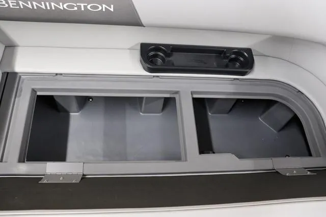 Slide: The Image of 2024 Bennington 22 SVL storage compartments with cup holders, showcasing practical boat interior design. - 28