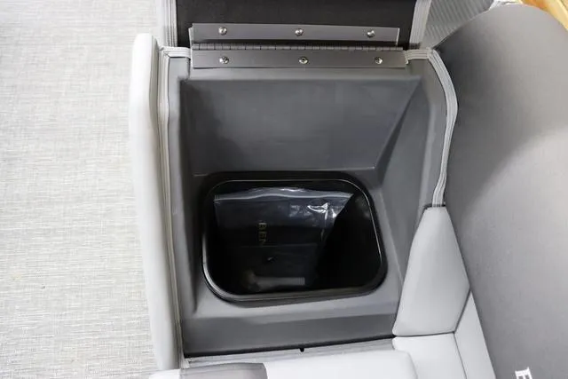 Slide: The Image of 2024 Bennington 22 SVL boat storage compartment with gray interior and cushioned seating. - 30