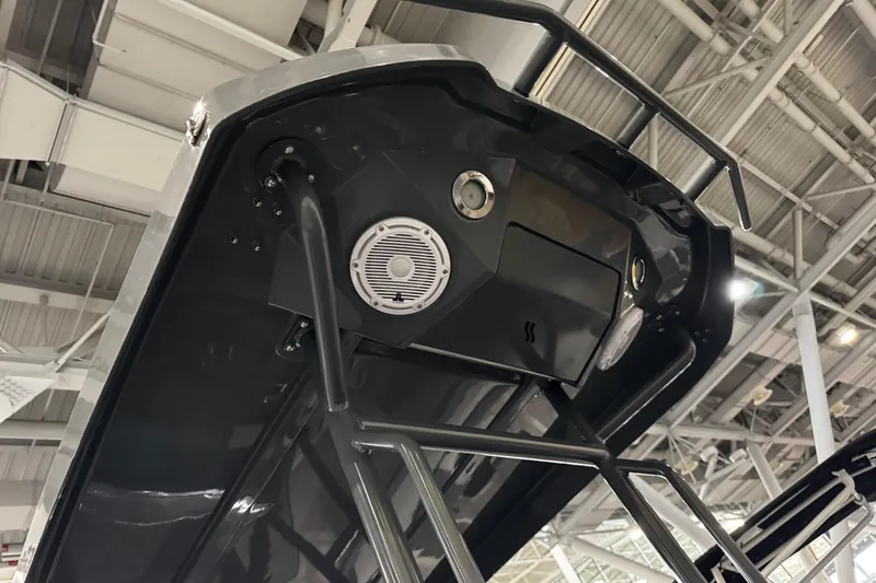 Slide: The Image of 2026 Highfield Sport 660 boat interior with steering console and seating in a showroom. - 10