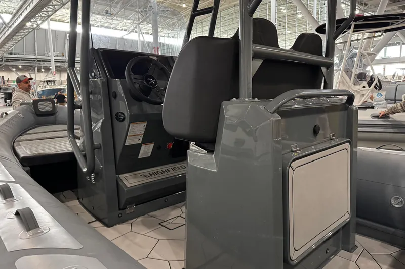 Slide: The Image of 2026 Highfield Sport 660 boat with Yamaha outboard motor in a showroom. - 9