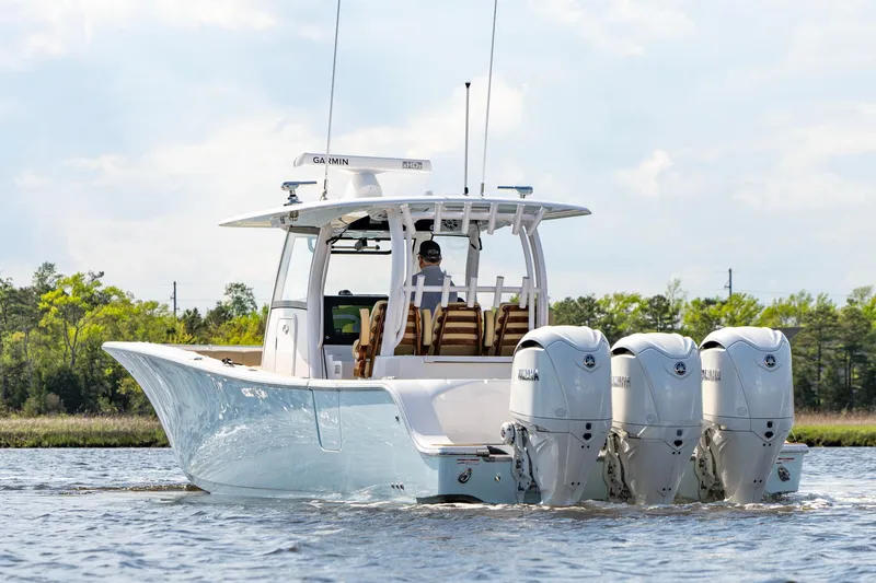 Slide: The Image of 2024 Sportsman Open 352 Center Console boat with triple engines on water. - 10