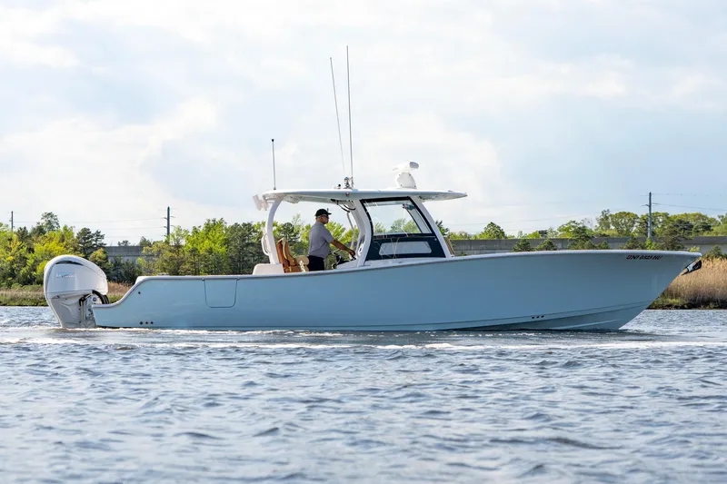 Slide: The Image of 2024 Sportsman Open 352 Center Console boat cruising on a calm waterway. - 14