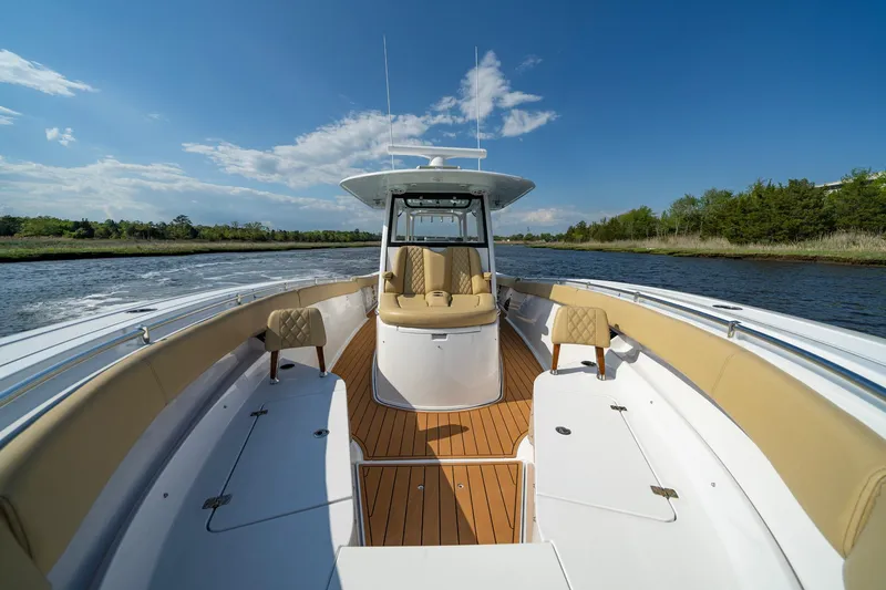 Slide: The Image of 2024 Sportsman Open 352 Center Console boat on water, featuring spacious seating and sleek design. - 18