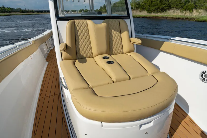 Slide: The Image of 2024 Sportsman Open 352 Center Console with luxurious tan seating on deck. - 19