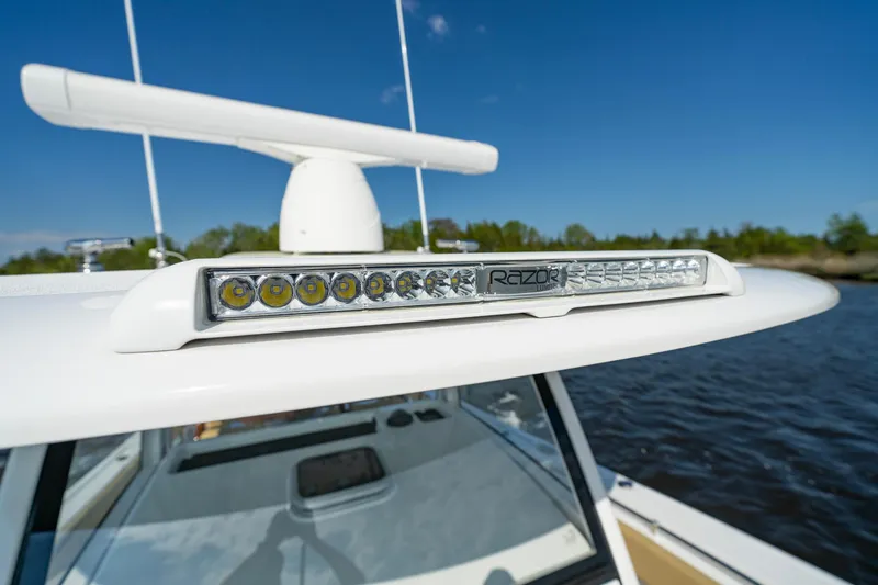 Slide: The Image of 2024 Sportsman Open 352 Center Console with LED light bar on calm water. - 20