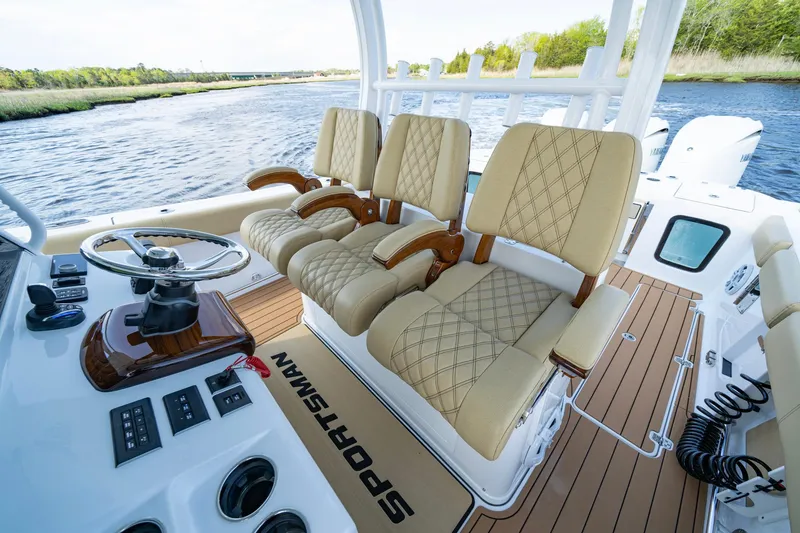Slide: The Image of 2024 Sportsman Open 352 Center Console with luxurious seating and modern controls on a scenic waterway. - 24