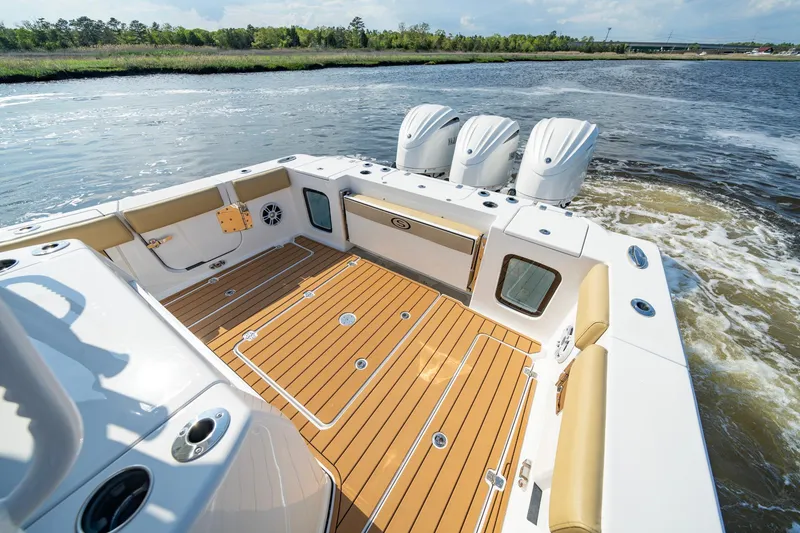 Slide: The Image of 2024 Sportsman Open 352 Center Console boat with triple engines on water. - 25