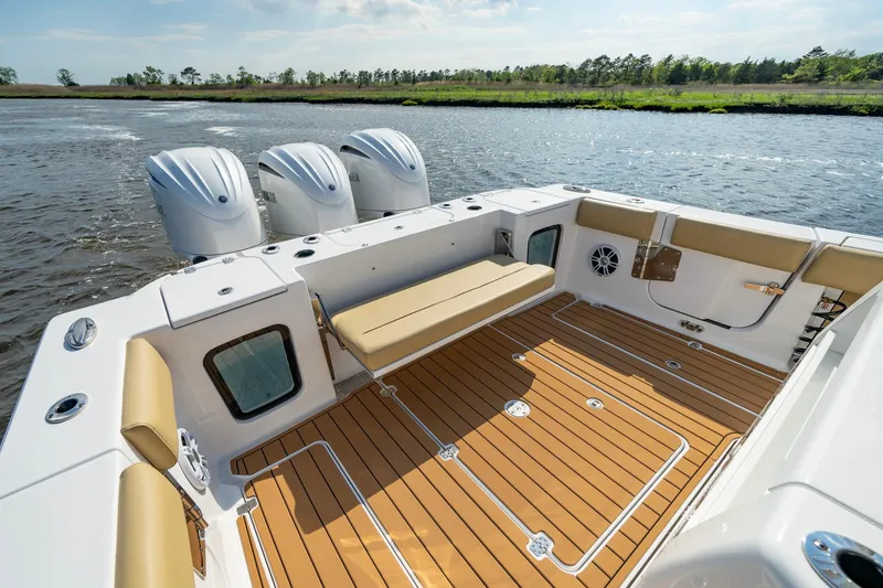 Slide: The Image of 2024 Sportsman Open 352 Center Console boat with triple engines on a sunny day. - 29