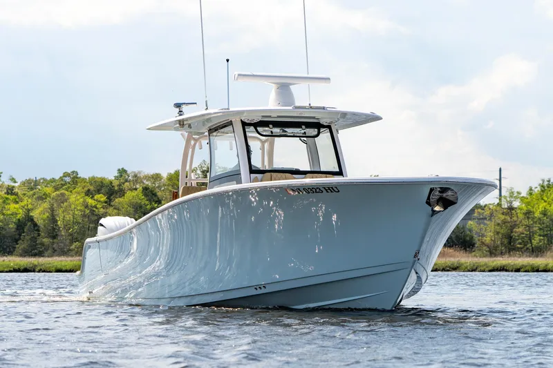 Slide: The Image of 2024 Sportsman Open 352 Center Console boat on water, showcasing sleek design and modern features. - 3