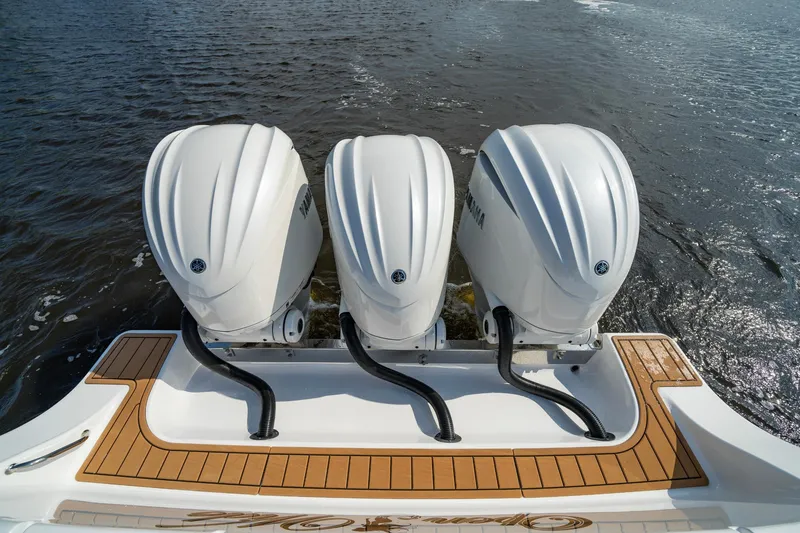 Slide: The Image of 2024 Sportsman Open 352 Center Console with triple outboard engines on water. - 30