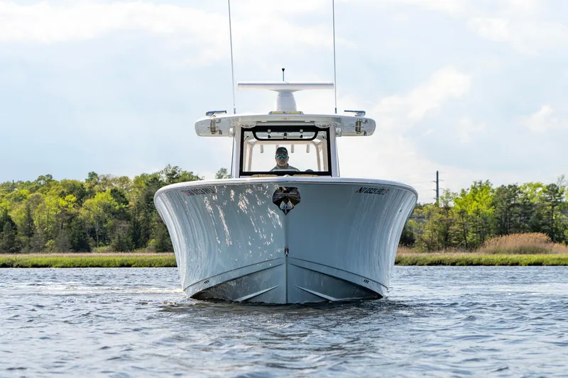 Slide: The Image of 2024 Sportsman Open 352 Center Console boat on water, front view. - 4