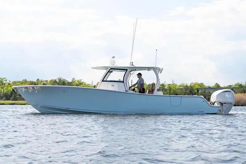 Slide: The Image of 2024 Sportsman Open 352 Center Console boat cruising on water. - 8