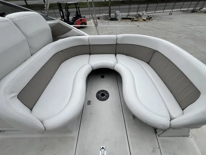 Slide: The Image of 2004 Four Winns 248 Vista boat with curved seating and beige upholstery. - 10